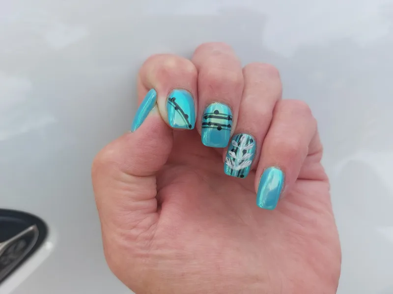 Teal cat eye nails with delicate black line art